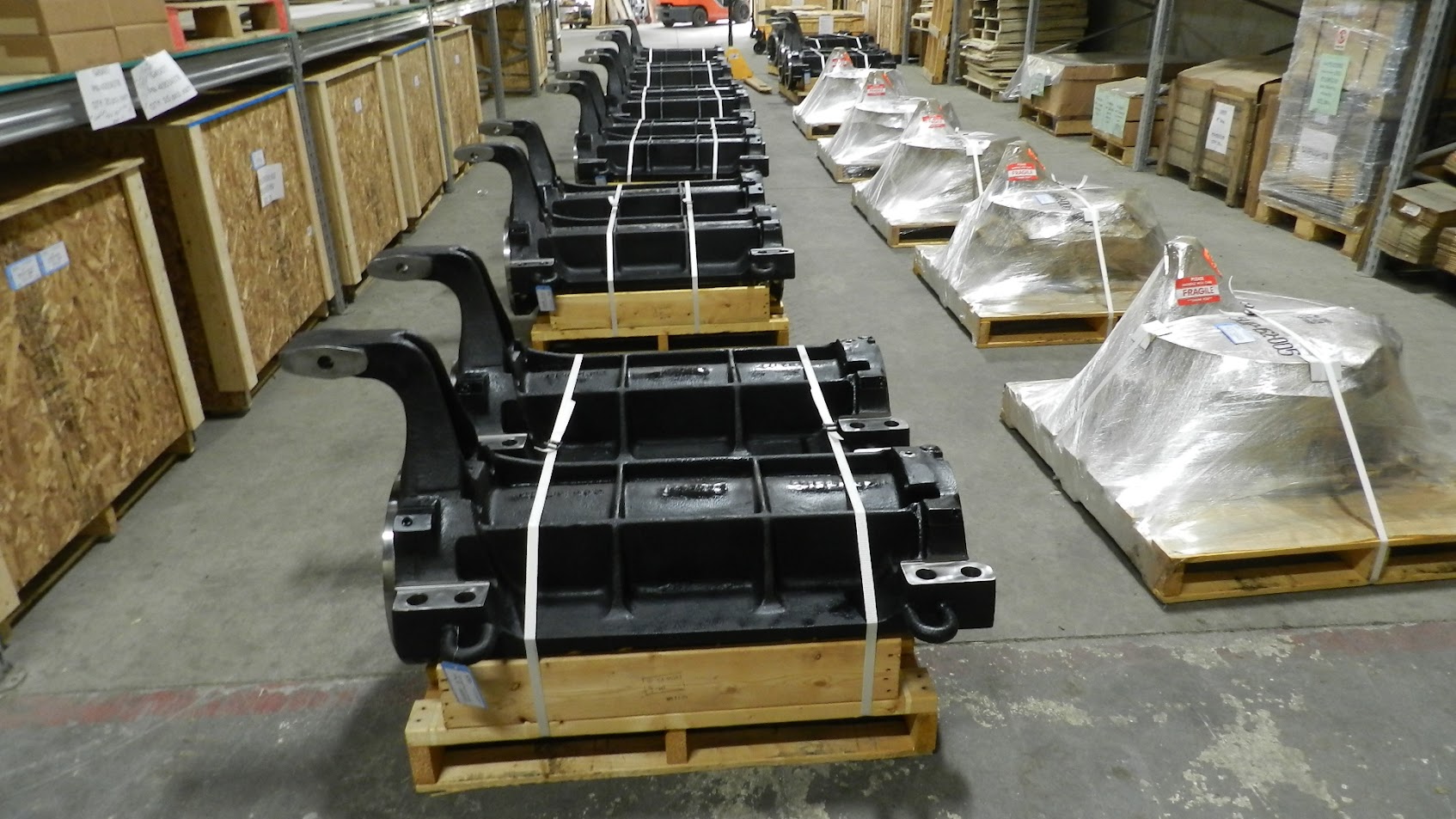 Locomotive truck frame components strapped to pallets for transport